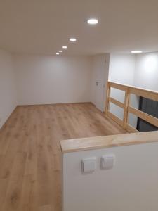 an empty room with a counter and a wooden floor at V Pražské in Hodkovice nad Mohelkou