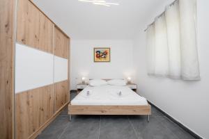 Posteľ alebo postele v izbe v ubytovaní Mariva Apartments