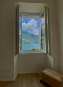 a room with a window with a view of the water at Laglio Charlie's House Lake View in Laglio