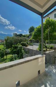 a view of a garden from a window in a house at Laglio Charlie's House Lake View in Laglio