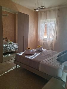 a bedroom with a large bed and a mirror at Posto al sole in Lido di Ostia