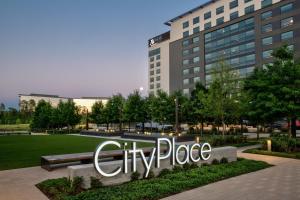 a city place sign in front of a building at Houston CityPlace Marriott at Springwoods Village in The Woodlands
