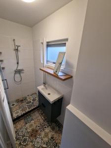 a bathroom with a sink and a window at Nature & golf Villa in Oosterhout +42 photos