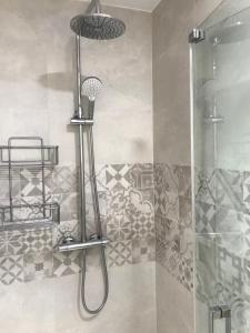 a shower with a shower head in a bathroom at Apartamento Arturo Soria in Madrid