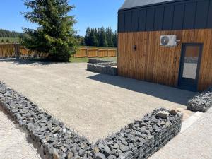 a building with a pile of rocks next to a house at Polana Modraszek in Lasowka +21 photos
