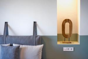 een bed met 2 kussens en een houten hoofdeinde bij Veneto Sea View Apartments in Stalida