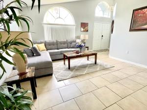 a living room with a couch and a table at Fabulous 4 Bedrooms Villa with Private Pool 15 Min to Disney in Davenport