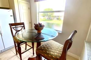 a table and chairs in a room with a window at Luxury condo near Wiggins pass beach & park in Naples