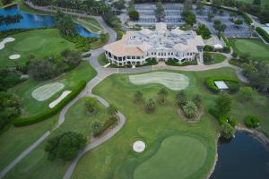 an aerial view of a golf course with a large house at Luxury condo near Wiggins pass beach & park in Naples