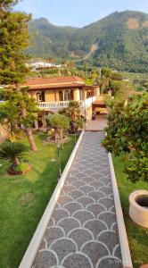 a walkway in front of a house with a yard at Villa Antonietta Ischia in Ischia