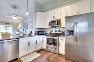a kitchen with white cabinets and stainless steel appliances at Pet-Friendly Orlando Home Near Hospitals in Orlando