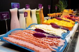 a display of meats and cheese on a buffet at Crowne Plaza Barranquilla by IHG in Barranquilla