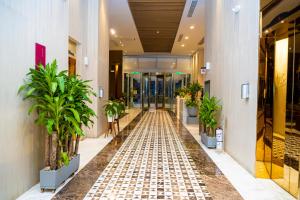 an empty hallway in a building with potted plants at Crowne Plaza Barranquilla by IHG in Barranquilla