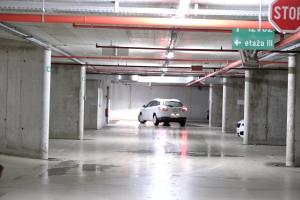 a car parked in a parking garage with a stop sign at Central Apartment Maister in Kranj