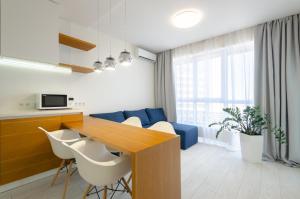 a kitchen and living room with a table and chairs at 1996 Kvartet Apartment in Kyiv