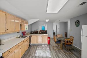 a kitchen with wooden cabinets and a table and a dining room at Axtons Bass City Lake Front Resort in Emory