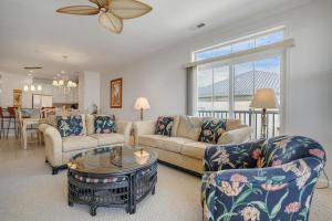 a living room with two couches and a table at Sunset Island Luxury 3BR Unit – Free Linen Package in Ocean City
