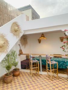 a balcony with two chairs and a bed at Riad Yu Yu in Marrakesh