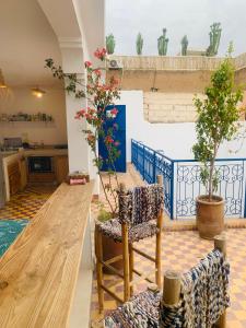 a living room with a table and a chair at Riad Yu Yu in Marrakech +101 photos