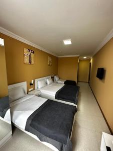 Postel nebo postele na pokoji v ubytování Hotel Brighton