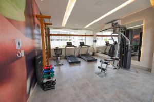 a gym with several treadmills and a tv in a room at MANA BEACH EXPERIENCE by AFT Porto de Galinhas, Muro Alto in Porto De Galinhas