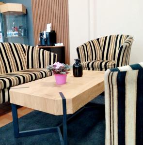two chairs and a coffee table in a room at Hostel Riga KVANT in Rīga