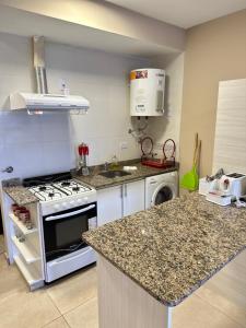 a kitchen with a stove and a counter top at TempoStay Monoambiente in San Miguel de Tucumán