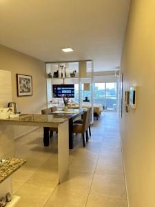 a dining room and living room with a long table at TempoStay Monoambiente in San Miguel de Tucumán