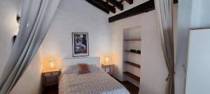 ein kleines Schlafzimmer mit einem Bett und zwei Nachttischen in der Unterkunft Apartamento tranquilo en el centro de Conil in Conil de la Frontera
