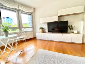 a living room with a large flat screen tv at Blue house Bermeo in Bermeo