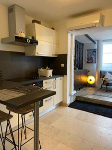 una cocina con armarios blancos y una mesa con sillas. en Apartment Paris, en Njivice