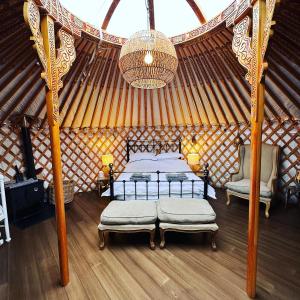 a bedroom with two beds in a yurt at Buzzard Holt Hosting in Buckingham
