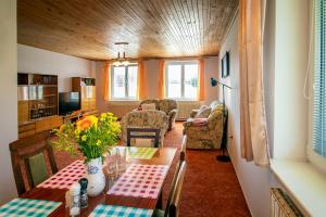 a dining room with a table and chairs at Chalupa Anežka in Frymburk