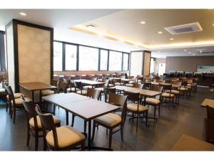a dining room with tables and chairs and windows at HOTEL LANTANA OSAKA - Vacation STAY 44971v in Osaka
