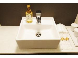 a white sink with a bottle on top of it at HOTEL LANTANA OSAKA - Vacation STAY 44968v in Osaka