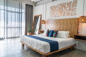 a bedroom with a large bed with blue pillows at Hotel Boutique Marrakesh in Villa Corona