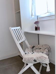 a white chair sitting in a room with a counter at Résidence Colombara in Cargèse