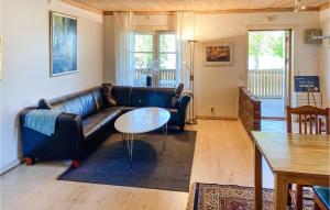 a living room with a leather couch and a table at Awesome Apartment In Huskvarna With Wifi in Huskvarna