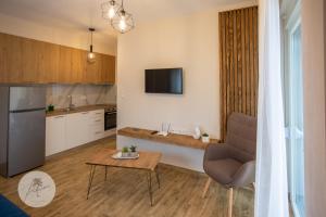 a kitchen and living room with a couch and a table at PALMERA STUDIOS in Ofrínion