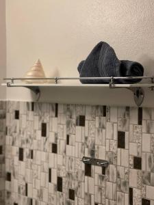 a shelf in a bathroom with a towel at beach room in Snogebæk