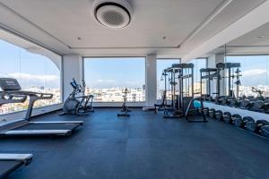 a gym with treadmills and exercise equipment in a building at Brickell Apart Hotel in Santo Domingo