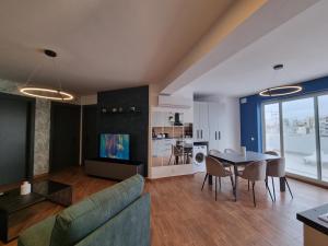 a living room with a couch and a table at KORZO SUITES MSIDA LUXURY PENTHOUSE WITH POOL in Msida