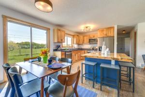 a kitchen with a table and chairs and a large window at Family-Friendly Lander Home Rental Yard, Patio! in Lander