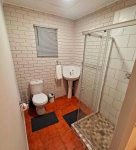 a bathroom with a toilet and a sink at Woodgate Cottage in Howick