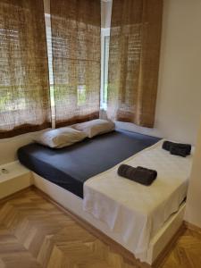 two beds in a room with two windows at El Mundo Suites in Antalya