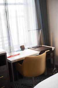 a desk with a chair in front of a window at Renaissance Pittsburgh Hotel in Pittsburgh