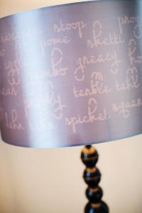 a close up of a purple lampshade withletters on it at Renaissance Pittsburgh Hotel in Pittsburgh