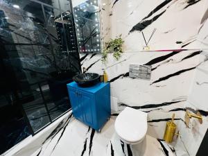 a bathroom with a toilet and a blue cabinet at Apartament Plaja Neversea in Constanţa +14 photos