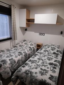 um quarto com uma cama com um cobertor com palmeiras em L EVASION em Pont-Aven