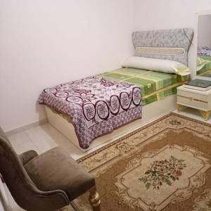 a bedroom with a bed and a couch and a chair at Appartement à Alexandrie cleopatra families only in Alexandria